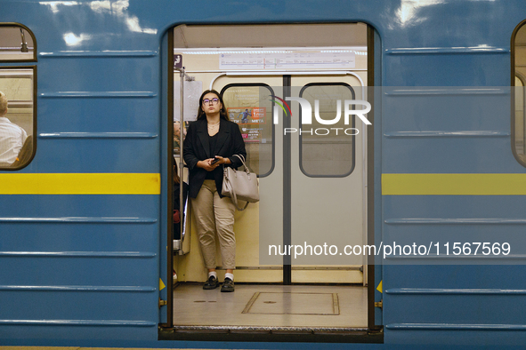 A passenger is on the train at the Demiivska metro station after the traffic is launched following nine months of repairs in the tunnel betw...