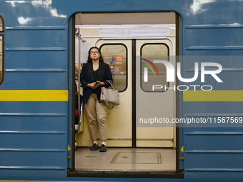 A passenger is on the train at the Demiivska metro station after the traffic is launched following nine months of repairs in the tunnel betw...