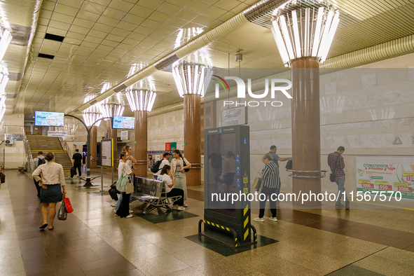 Passengers stay on the platform of the Demiivska metro station after the traffic launches following nine months of repairs in the tunnel bet...