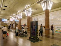 Passengers stay on the platform of the Demiivska metro station after the traffic launches following nine months of repairs in the tunnel bet...