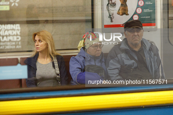 Passengers are in a carriage of a Kyiv Metro train at the Demiivska metro station after the traffic relaunches following nine months of repa...