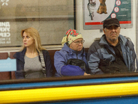 Passengers are in a carriage of a Kyiv Metro train at the Demiivska metro station after the traffic relaunches following nine months of repa...