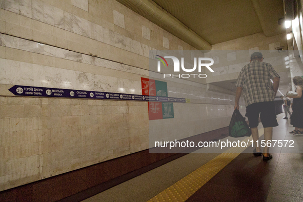 Passengers stay on the platform of the Demiivska metro station after the traffic launches following nine months of repairs in the tunnel bet...