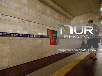 Passengers stay on the platform of the Demiivska metro station after the traffic launches following nine months of repairs in the tunnel bet...