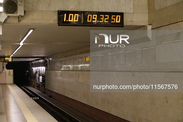 A digital clock is at the Demiivska metro station after the traffic launches following nine months of repairs in the tunnel between Demiivsk...