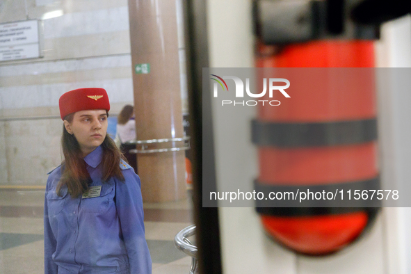 A Kyiv Metro worker stands on the platform of the Demiivska metro station after the traffic relaunches following nine months of repairs in t...