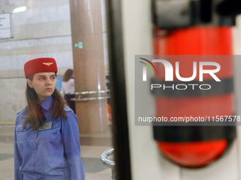 A Kyiv Metro worker stands on the platform of the Demiivska metro station after the traffic relaunches following nine months of repairs in t...