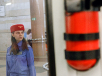 A Kyiv Metro worker stands on the platform of the Demiivska metro station after the traffic relaunches following nine months of repairs in t...