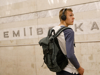 A passenger is at the Demiivska metro station after the traffic launches following nine months of repairs in the tunnel between Demiivska an...