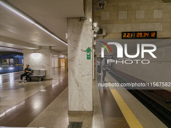 Passengers stay on the platform of the Demiivska metro station after the traffic launches following nine months of repairs in the tunnel bet...