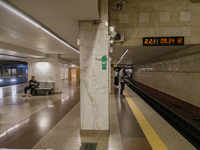 Passengers stay on the platform of the Demiivska metro station after the traffic launches following nine months of repairs in the tunnel bet...