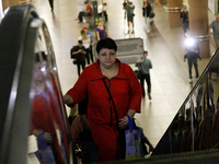 Passengers use escalators at the Demiivska metro station after the traffic launches following nine months of repairs in the tunnel between D...