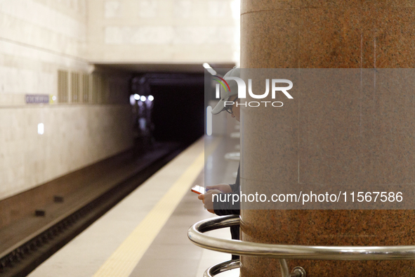 A passenger is at the Demiivska metro station after the traffic launches following nine months of repairs in the tunnel between Demiivska an...