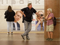 Passengers stay on the platform of the Demiivska metro station after the traffic launches following nine months of repairs in the tunnel bet...