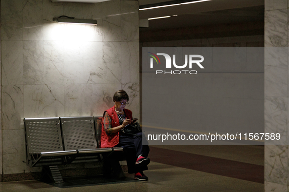 A passenger is at the Demiivska metro station after the traffic launches following nine months of repairs in the tunnel between Demiivska an...