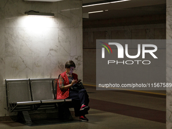 A passenger is at the Demiivska metro station after the traffic launches following nine months of repairs in the tunnel between Demiivska an...