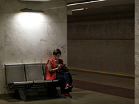 A passenger is at the Demiivska metro station after the traffic launches following nine months of repairs in the tunnel between Demiivska an...