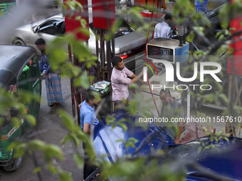 Vehicles queue to get fuel near a gas station during an acute gas shortage in Dhaka, Bangladesh, on September 12, 2024. (