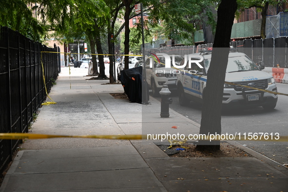 Crime scene tape blocks the area. A man is shot in the back multiple times in Manhattan, New York, United States, on September 12, 2024. At...