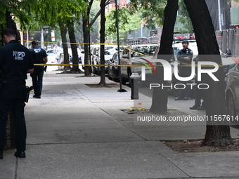 Police canvass the crime scene for evidence. A man is shot in the back multiple times in Manhattan, New York, United States, on September 12...