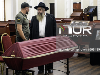 Ukrainian Jews, relatives, and friends attend a farewell ceremony for the late Ukrainian serviceman Matisyahu (Anton) Samborskiy at the Cent...