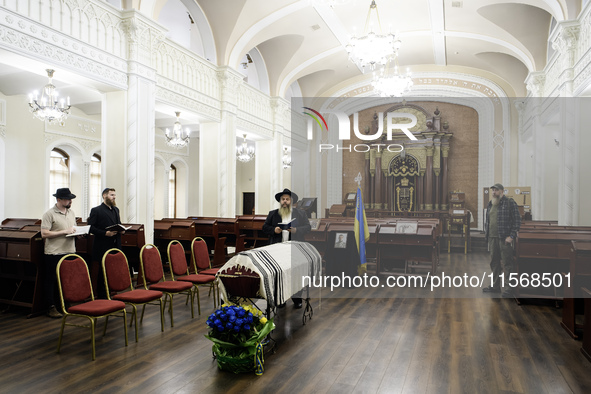 Ukrainian Jews, relatives, and friends attend a farewell ceremony for the late Ukrainian serviceman Matisyahu (Anton) Samborskiy at the Cent...