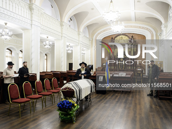 Ukrainian Jews, relatives, and friends attend a farewell ceremony for the late Ukrainian serviceman Matisyahu (Anton) Samborskiy at the Cent...