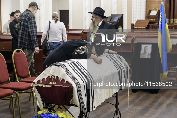 Ukrainian Jews, relatives, and friends attend a farewell ceremony for the late Ukrainian serviceman Matisyahu (Anton) Samborskiy at the Cent...