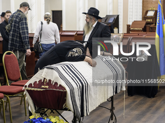 Ukrainian Jews, relatives, and friends attend a farewell ceremony for the late Ukrainian serviceman Matisyahu (Anton) Samborskiy at the Cent...