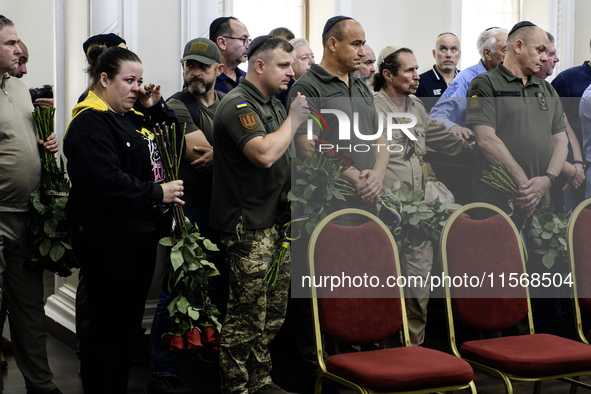 Ukrainian Jews, relatives, and friends attend a farewell ceremony for the late Ukrainian serviceman Matisyahu (Anton) Samborskiy at the Cent...