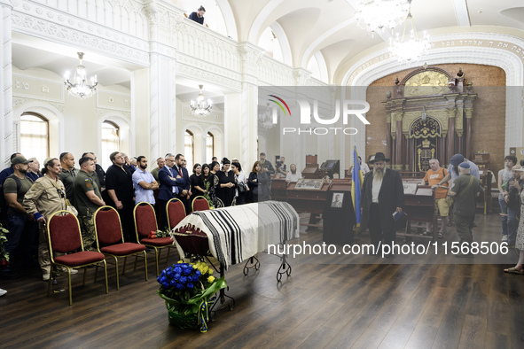 Ukrainian Jews, relatives, and friends attend a farewell ceremony for the late Ukrainian serviceman Matisyahu (Anton) Samborskiy at the Cent...