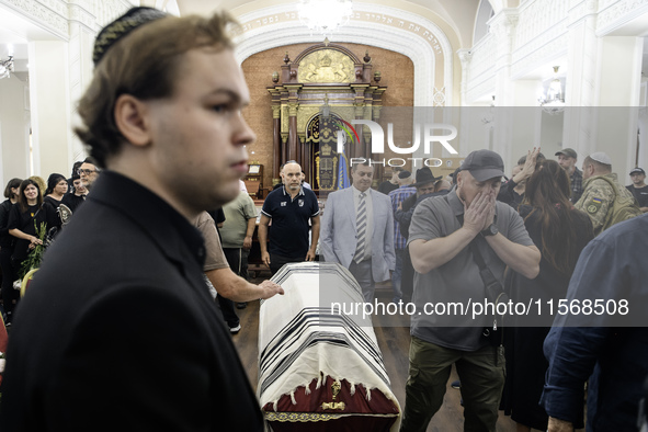 Ukrainian Jews, relatives, and friends attend a farewell ceremony for the late Ukrainian serviceman Matisyahu (Anton) Samborskiy at the Cent...