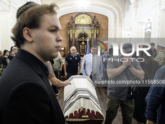 Ukrainian Jews, relatives, and friends attend a farewell ceremony for the late Ukrainian serviceman Matisyahu (Anton) Samborskiy at the Cent...