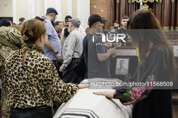 Ukrainian Jews, relatives, and friends attend a farewell ceremony for the late Ukrainian serviceman Matisyahu (Anton) Samborskiy at the Cent...