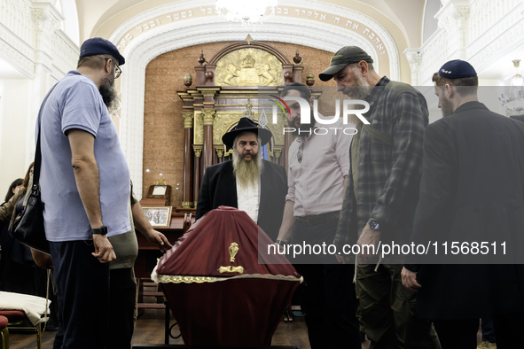 Ukrainian Jews, relatives, and friends attend a farewell ceremony for the late Ukrainian serviceman Matisyahu (Anton) Samborskiy at the Cent...