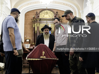 Ukrainian Jews, relatives, and friends attend a farewell ceremony for the late Ukrainian serviceman Matisyahu (Anton) Samborskiy at the Cent...