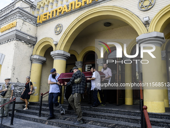 Ukrainian Jews, relatives, and friends attend a farewell ceremony for the late Ukrainian serviceman Matisyahu (Anton) Samborskiy at the Cent...