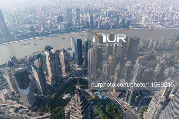 An aerial photo shows high-rise buildings along the Huangpu River in Lujiazui, Shanghai, China, on May 19, 2017. 