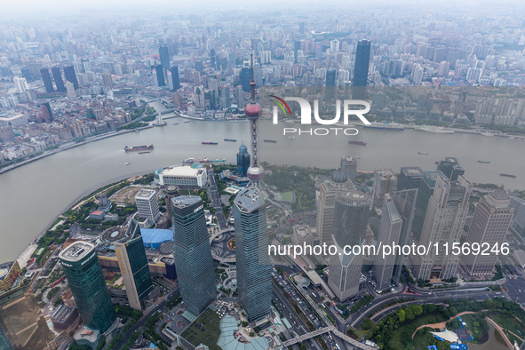 An aerial photo shows high-rise buildings along the Huangpu River in Lujiazui, Shanghai, China, on May 19, 2017. 