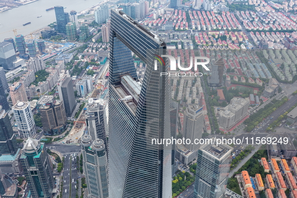 An aerial photo shows high-rise buildings along the Huangpu River in Lujiazui, Shanghai, China, on May 19, 2017. 