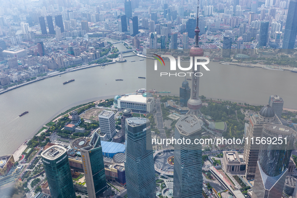 An aerial photo shows high-rise buildings along the Huangpu River in Lujiazui, Shanghai, China, on May 19, 2017. 