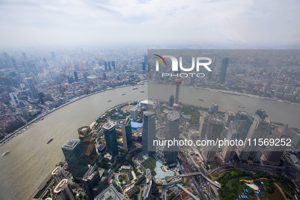 An aerial photo shows high-rise buildings along the Huangpu River in Lujiazui, Shanghai, China, on May 19, 2017. 