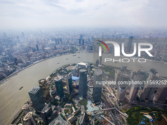 An aerial photo shows high-rise buildings along the Huangpu River in Lujiazui, Shanghai, China, on May 19, 2017. (