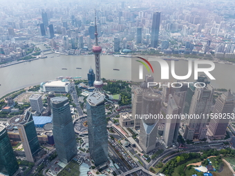 An aerial photo shows high-rise buildings along the Huangpu River in Lujiazui, Shanghai, China, on May 19, 2017. (