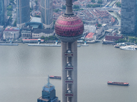 An aerial photo shows high-rise buildings along the Huangpu River in Lujiazui, Shanghai, China, on May 19, 2017. (