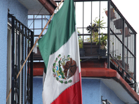 A Mexican flag hangs on a window of a house on the occasion of the national holidays in Mexico City, Mexico, on September 12, 2024. (