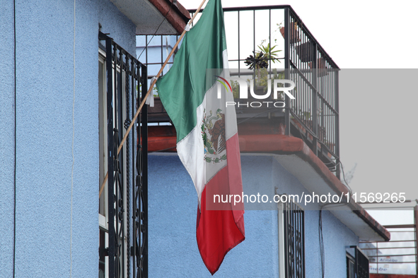 A Mexican flag hangs on a window of a house on the occasion of the national holidays in Mexico City, Mexico, on September 12, 2024. 