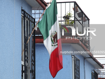 A Mexican flag hangs on a window of a house on the occasion of the national holidays in Mexico City, Mexico, on September 12, 2024. (