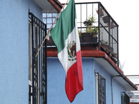 A Mexican flag hangs on a window of a house on the occasion of the national holidays in Mexico City, Mexico, on September 12, 2024. (