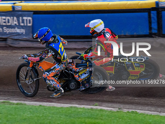 Mickie Simpson of the Sheffield Tiger Cubs in blue rides inside Max James, the guest rider for the Belle Vue Colts in white, during the WSRA...